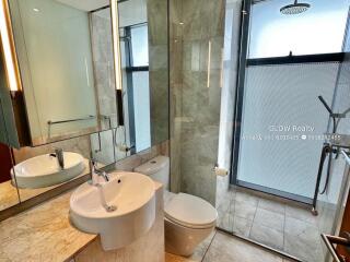 Modern bathroom with glass shower enclosure and sleek fixtures