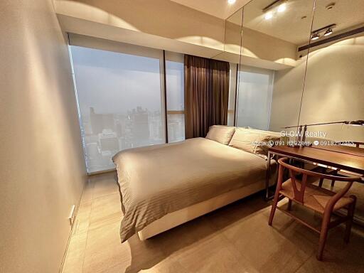 Cozy bedroom with large window and city view