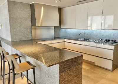 Modern kitchen with granite countertops and white cabinets