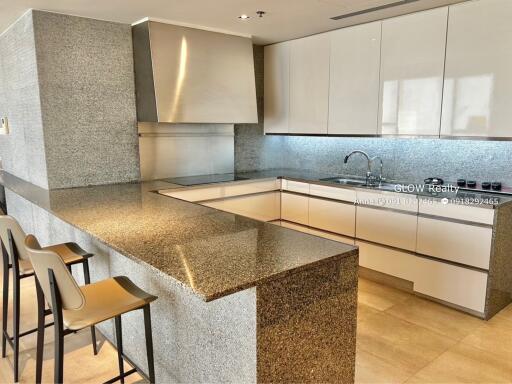 Modern kitchen with granite countertops and white cabinets