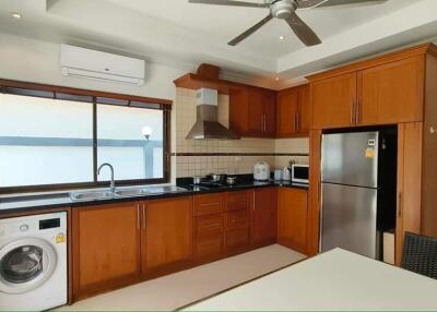 Modern kitchen with wooden cabinets and stainless steel appliances