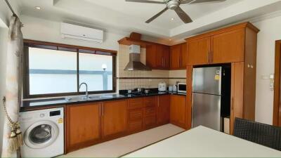 Modern kitchen with wooden cabinets and stainless steel appliances