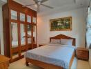 Bedroom with wooden furnishings and a large mirrored wardrobe