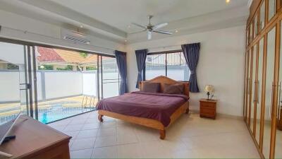 Spacious master bedroom with pool view