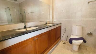 Modern bathroom with double sink and toilet