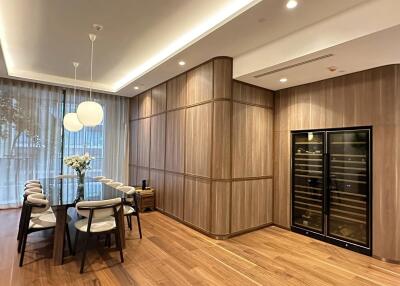 Modern dining room with wooden flooring and a wine cooler
