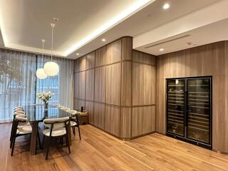 Modern dining room with wooden flooring and a wine cooler