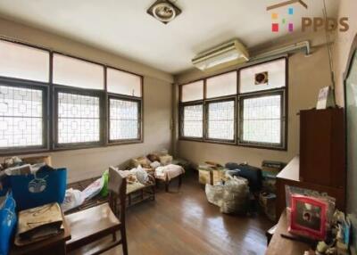 Bedroom with multiple windows and air conditioning unit