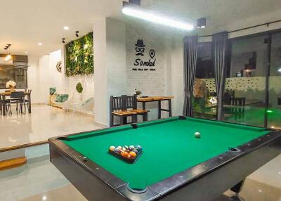 Modern recreational area with pool table and view of dining space
