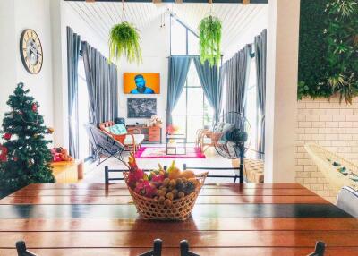 Bright and vibrant living room with modern decor, a television, and plants
