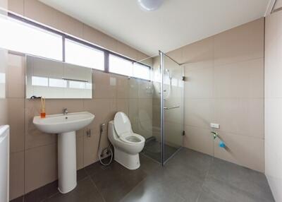 Modern bathroom with large tiles and glass shower enclosure