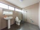 Modern bathroom with large tiles and glass shower enclosure