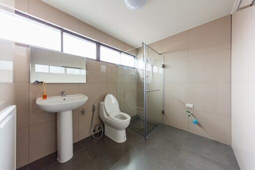 Modern bathroom with large tiles and glass shower enclosure