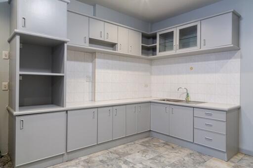 Modern kitchen with gray cabinets and tile flooring