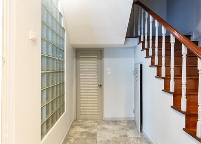 Staircase and hallway with tiled floor
