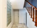 Staircase and hallway with tiled floor