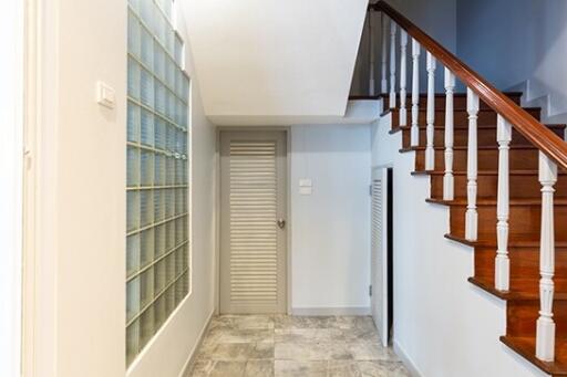 Staircase and hallway with tiled floor