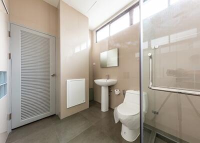 Modern minimalist bathroom with glass-enclosed shower