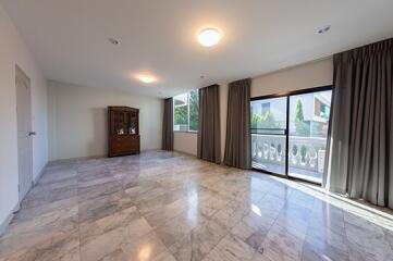 Spacious living room with marble flooring and large windows