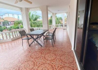 Spacious balcony with outdoor furniture and ceiling fan