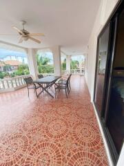 Spacious balcony with outdoor furniture and ceiling fan