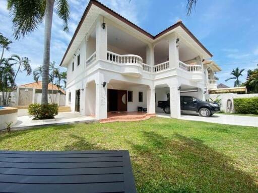 Two-story white house with columns and a driveway