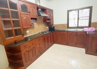 Spacious kitchen with wooden cabinets