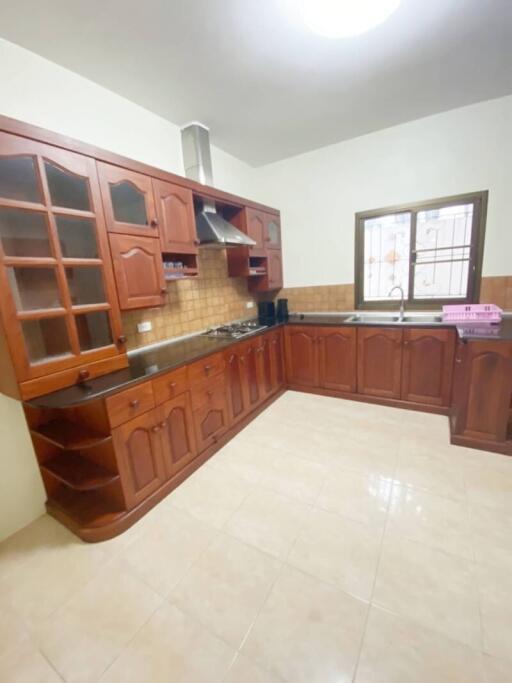 Spacious kitchen with wooden cabinets