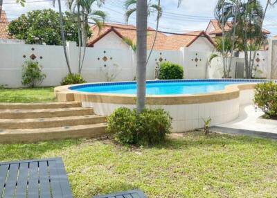 Backyard with swimming pool and palm trees