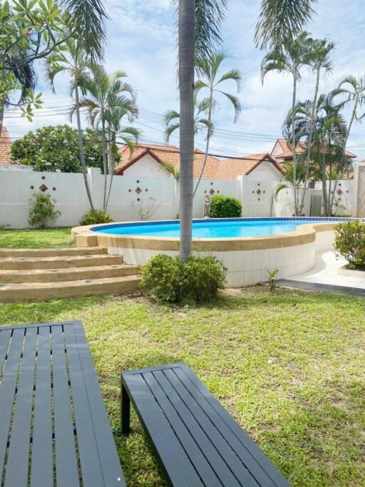 Backyard with swimming pool and palm trees