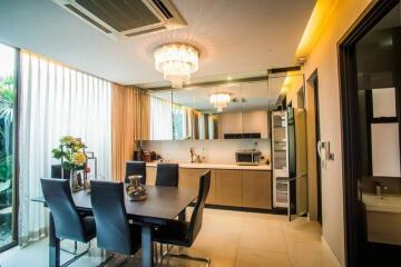 Modern kitchen with dining area and contemporary lighting