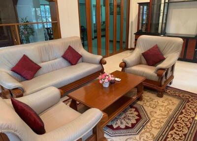Living room with sofa set, coffee table, and wooden furniture