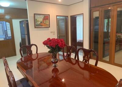 Spacious dining room with wooden table and decorative painting
