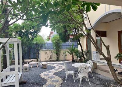 Outdoor backyard area with seating and garden