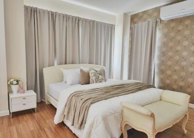 Modern bedroom with double bed, wooden floor, nightstand, curtains, air conditioner and decorative wall