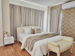 Modern bedroom with double bed, wooden floor, nightstand, curtains, air conditioner and decorative wall