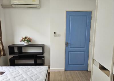 Bedroom with blue door and air conditioning
