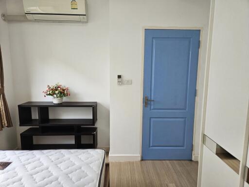 Bedroom with blue door and air conditioning