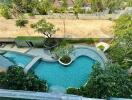 Aerial view of a swimming pool with surrounding greenery