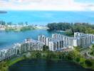 Aerial view of modern beachfront condominium buildings surrounded by greenery with a beautiful coastal backdrop