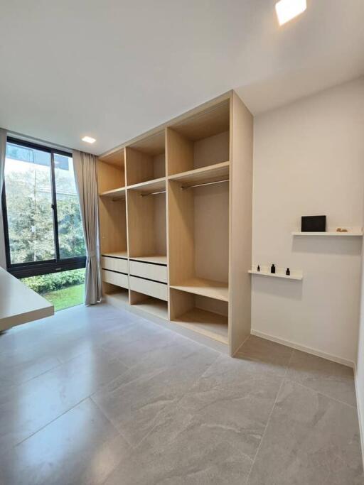 Spacious bedroom with built-in wardrobes and large windows