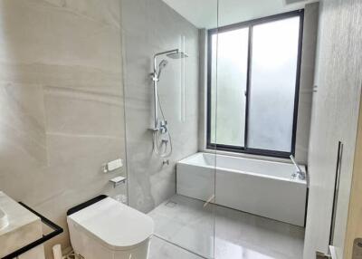 Minimalist bathroom with glass shower and bathtub