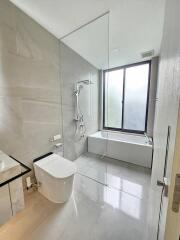 Minimalist bathroom with glass shower and bathtub