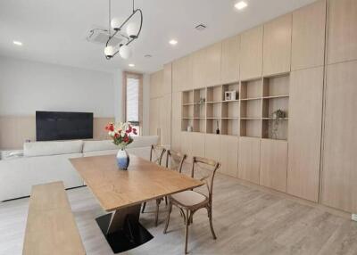Modern living room with dining area and built-in shelving