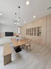 Modern living room with dining area and built-in shelving