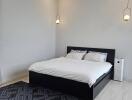 Modern bedroom with double bed and contemporary lighting