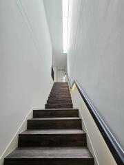 Modern indoor staircase with wooden steps and handrail