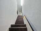 Modern indoor staircase with wooden steps and handrail