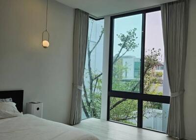 Modern bedroom with large windows and natural light