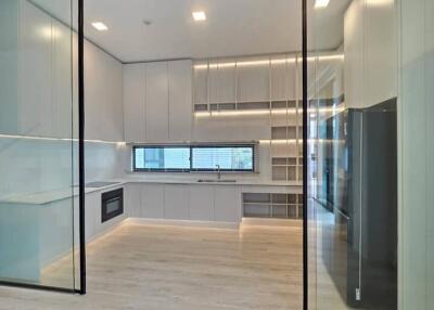 Modern kitchen with glass partitions and high-end appliances